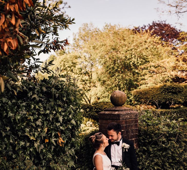 Bride & groom hold one another outdoors on their wedding day