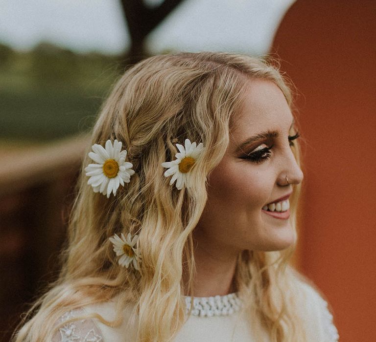 Beautiful bride with long wavy wedding hair and fresh flower decor