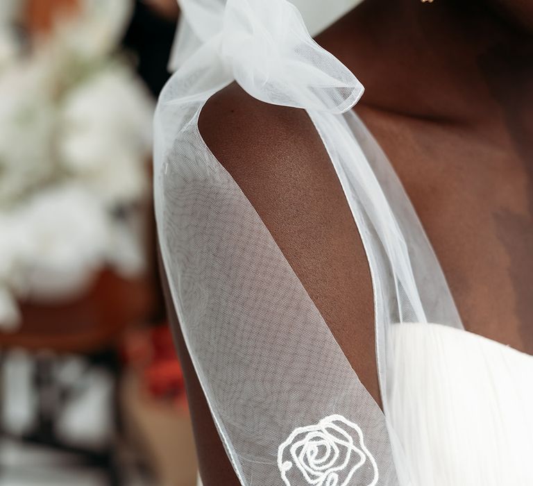 Shoulder bow on a wedding dress with embroidered rose detail