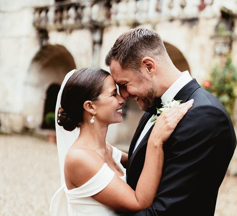 Bride & groom look lovingly at one another on their wedding day after ceremony