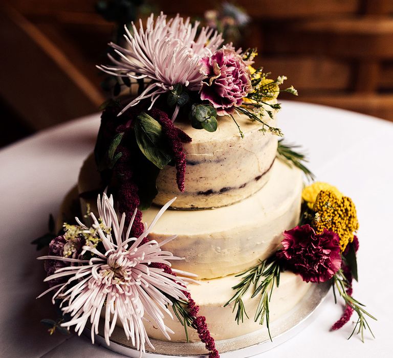 Rustic semi-naked wedding cake with flower decor