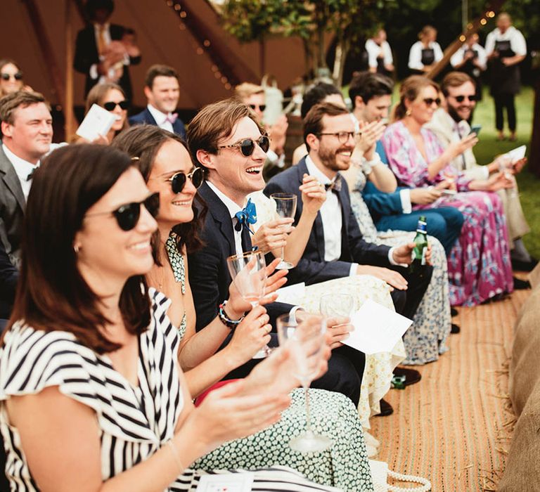 Wedding guests watch as bride & groom marry