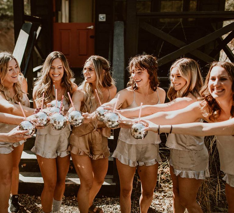 Bride celebrates with her bridesmaids who wear different styled gowns