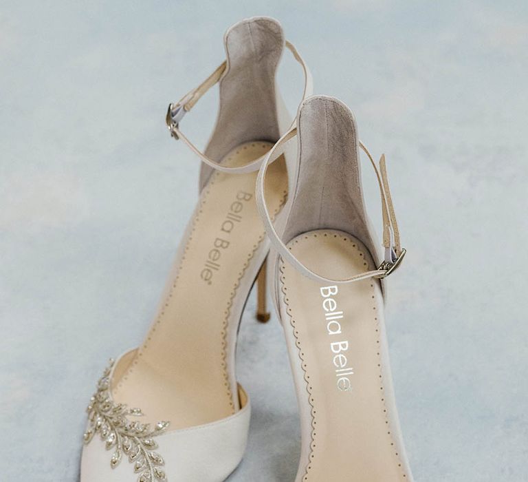 White pointed closed-toe wedding shoe with crystal leaf design embellishment