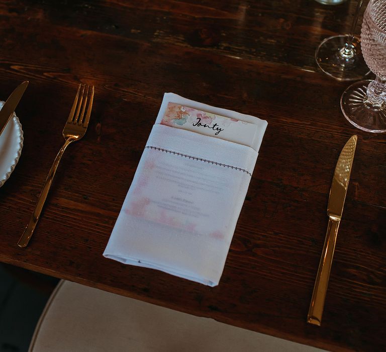 Multi-coloured water colour menu card and name place cards for table settings at relaxed festival style wedding