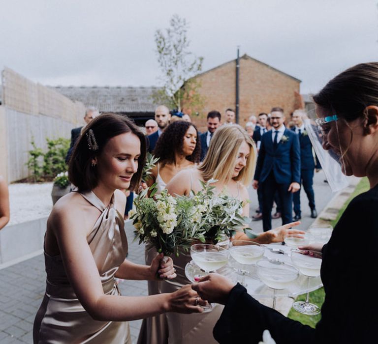 Bride in champagne gold satin bridesmaid dresses 