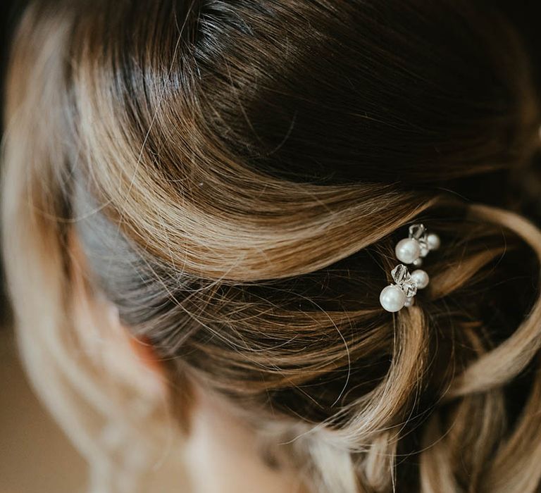 Bride with an updo with pearl hair pin accessories 