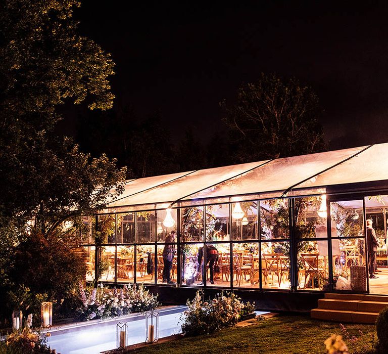 Glass marquee lit up for the evening 