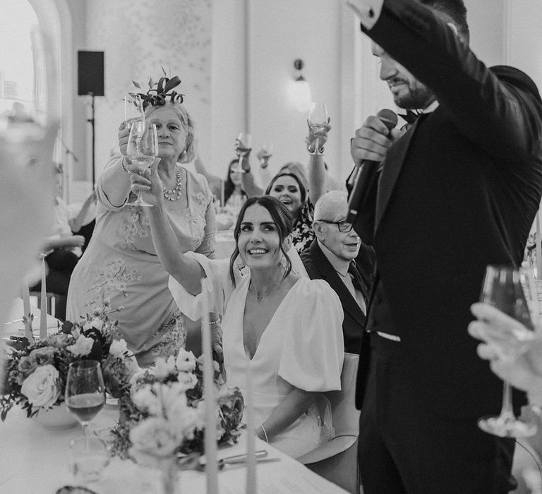 Groom raising a glass to bride and wedding guests during Somerset House reception