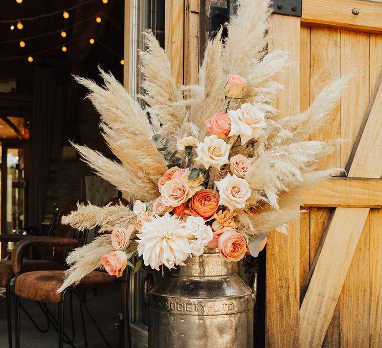 Boho wedding at Tythe Barn with pampas grass and orange and white wedding roses 