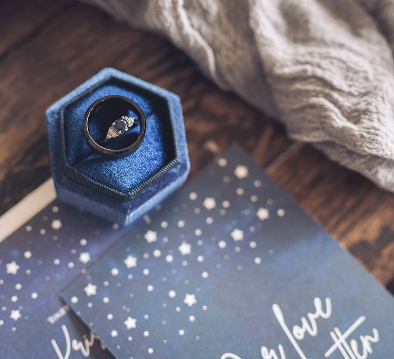 Hexagonal blue velvet ring box with the bride's sapphire ring with diamond with wedding band on star celestial theme wedding invitation 