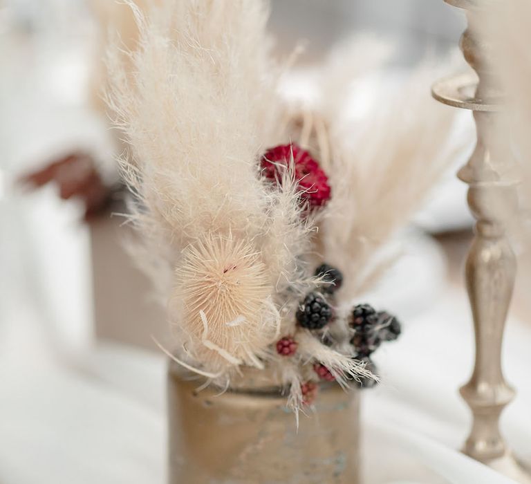 Pampas grass with dried berries in antique styled vase 