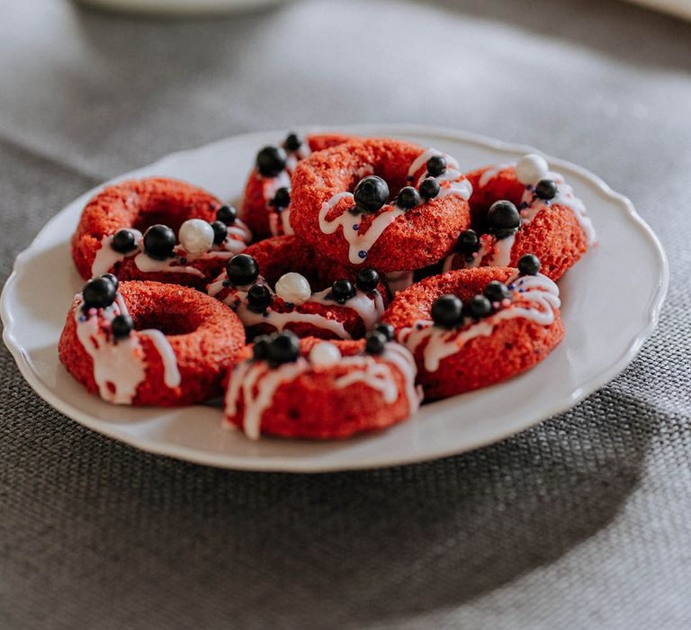 Red velvet wedding biscuits with blueberry decorations and white icing 