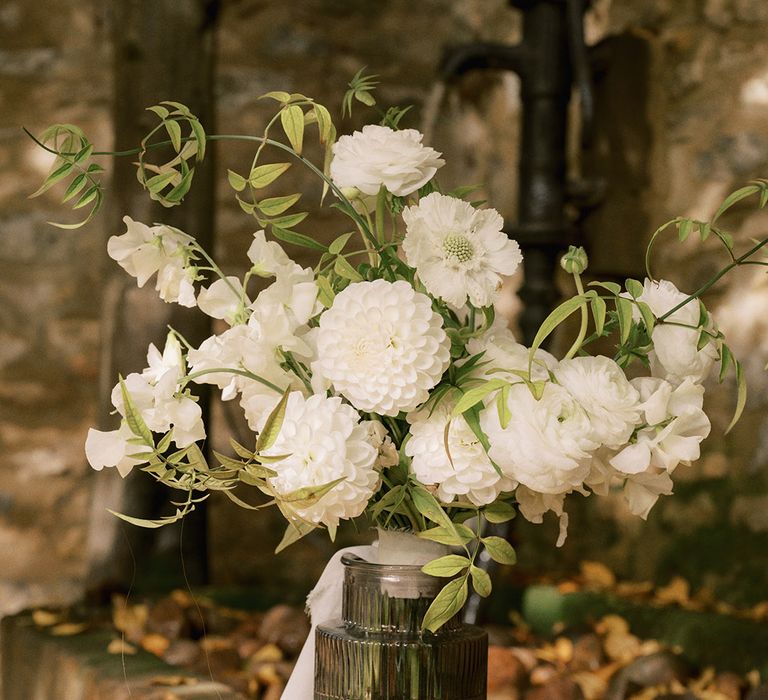 White dahlias and other white wedding flowers in an arrangement for a rustic luxe wedding at The Tythe Barn