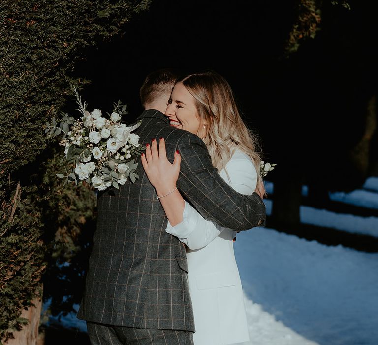 The bride and groom share an emotional embrace as they see each other for the first time ready for the wedding 