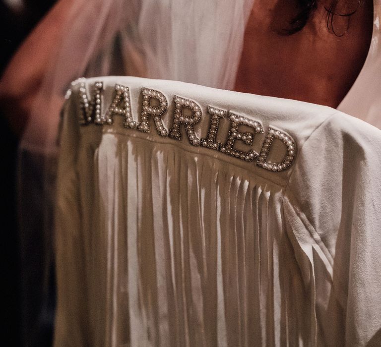 White suede tasselled bridal jacket with 'Just Married' written in pearls 