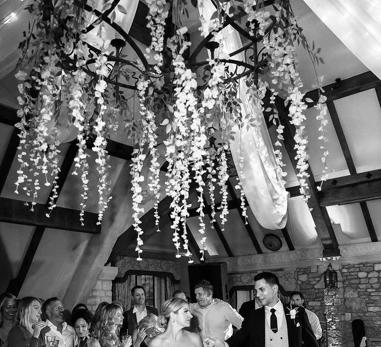 The bride and groom walk onto the dance floor together for their first dance 