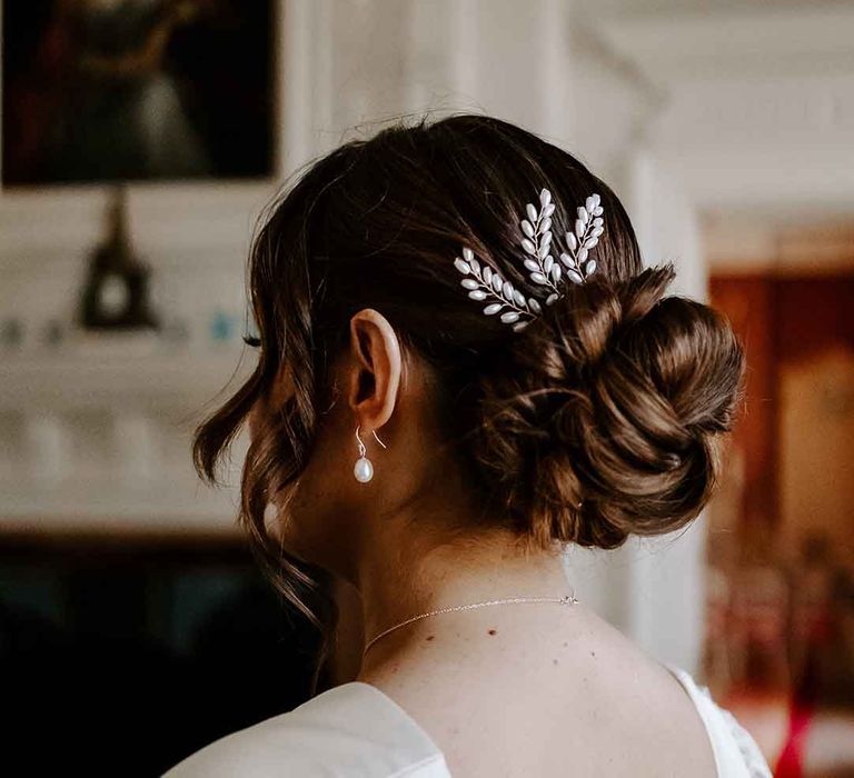 pinned bridal undo with shiny hair accessory 