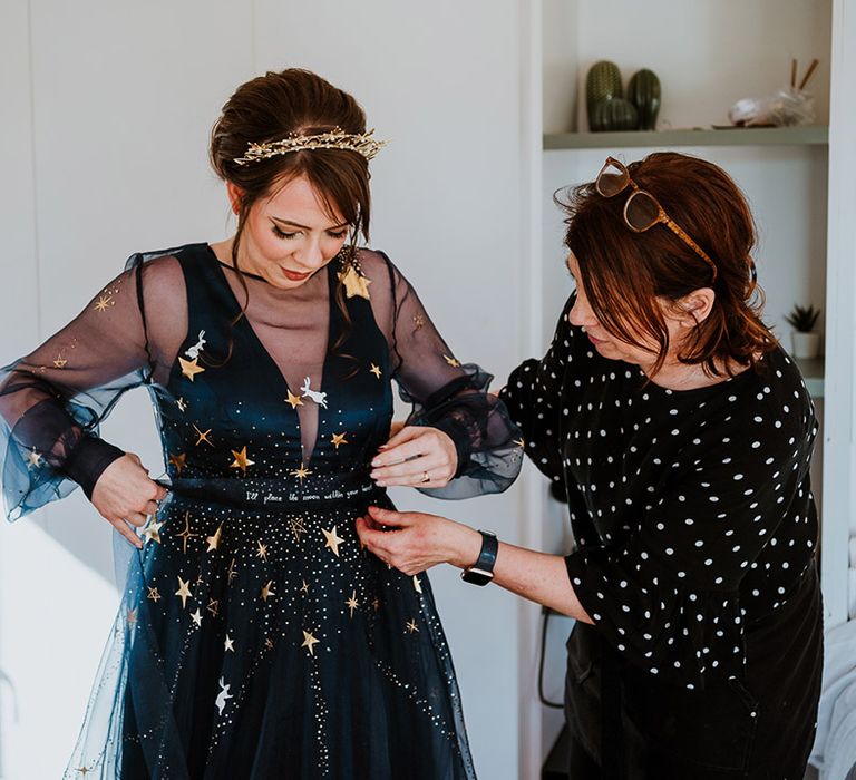 Bride in sheer navy blue wedding dress with gold stars and matching gold star crown headpiece 