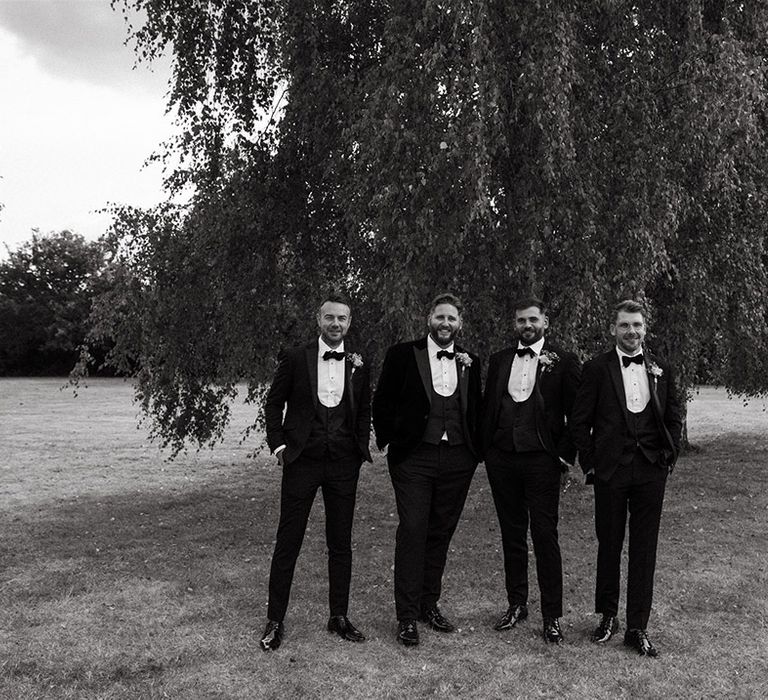 Group photo of the groomsmen in black tuxedos for the wedding day 