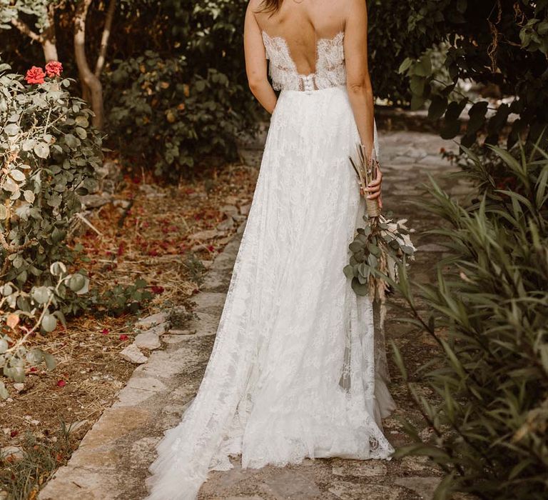 boho bride in a lace wedding dress with low back design