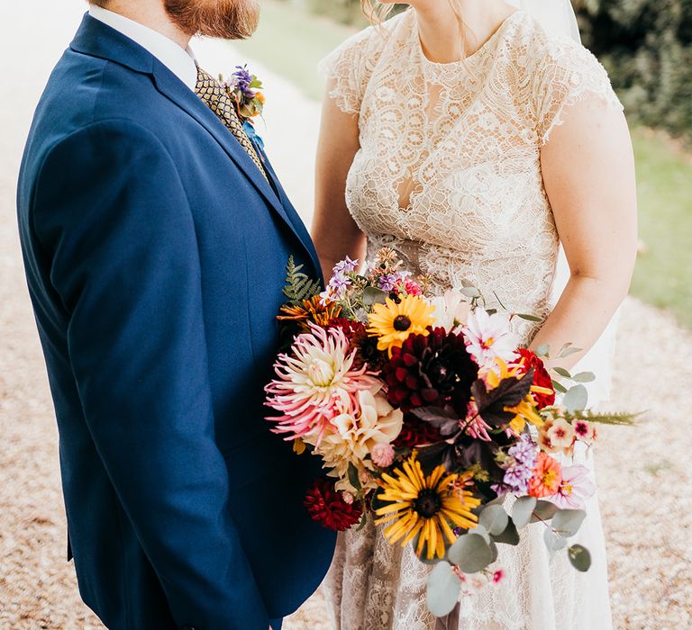 Bride in boho lace wedding dress with groom in blue wedding suit for country house wedding in Bristol 