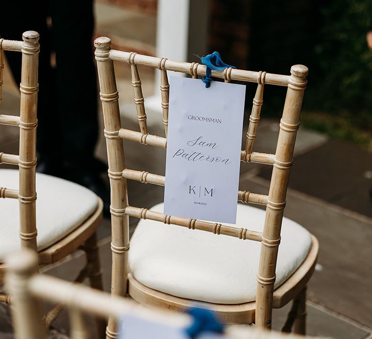 Reserved seat sign chair back decorations tied with blue ribbon 