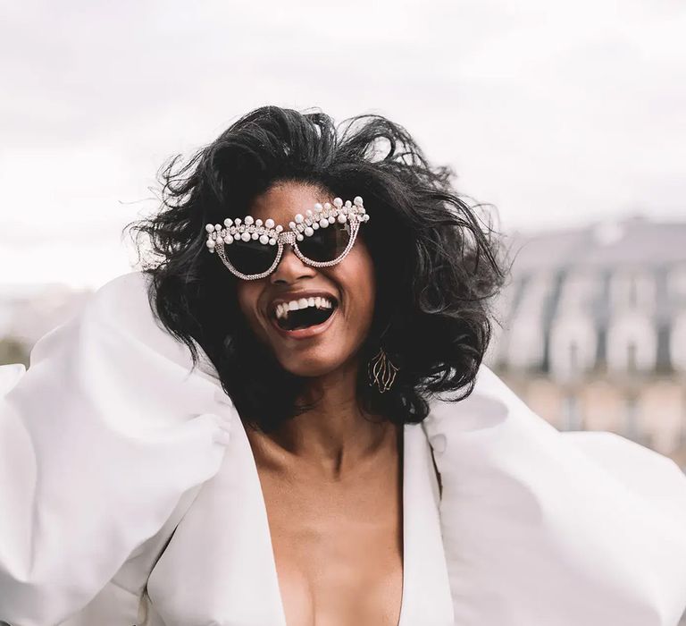 Elopement bride wearing fun pearl sunglasses with puff sleeve white wedding dress by Les Bandits Photography