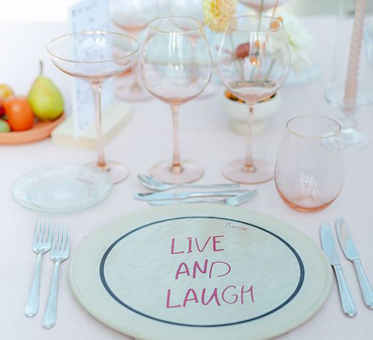 Pastel blue and pink table decor with plate reading: "live and laugh" by Fotoclipes Photography