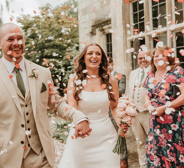 Colourful pastel confetti exit for bride and groom at registry office 