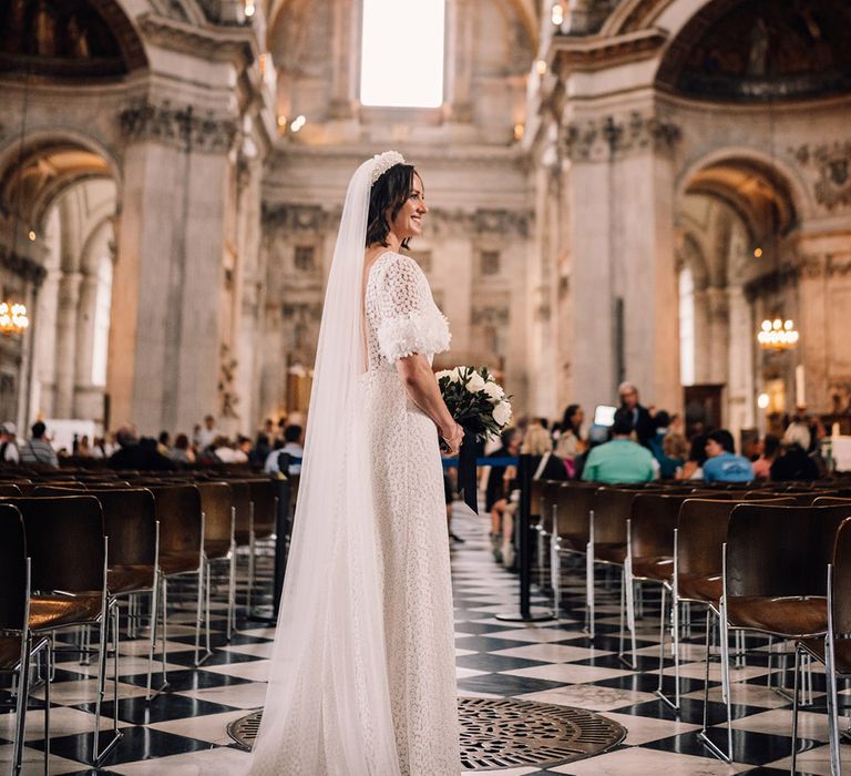 Bride in bespoke wedding dress at St. Paul's Cathedral for traditional church wedding ceremony 