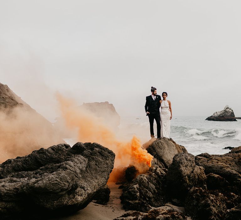 Moody elopement photography with orange smoke bombs 