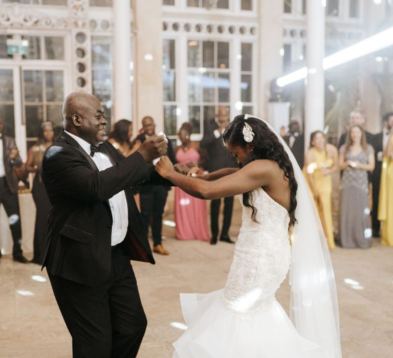 Bride in fishtail wedding dress dancing on the dance floor at Syon Park 