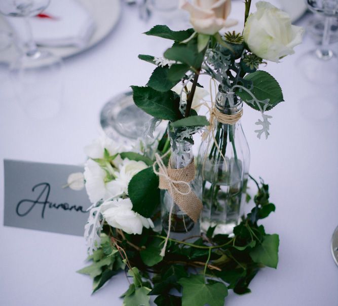 Flower stems in bottles for table centrepieces 