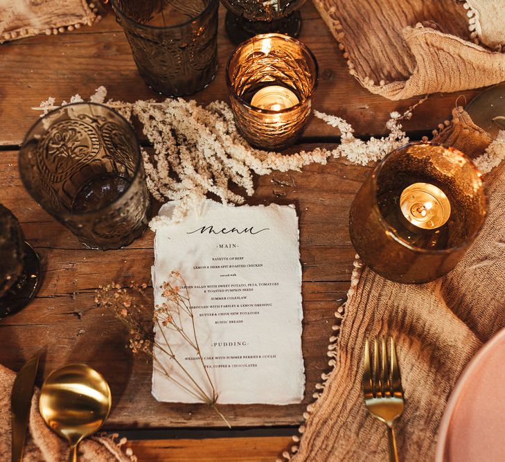 Coloured glass and votives with menu card 