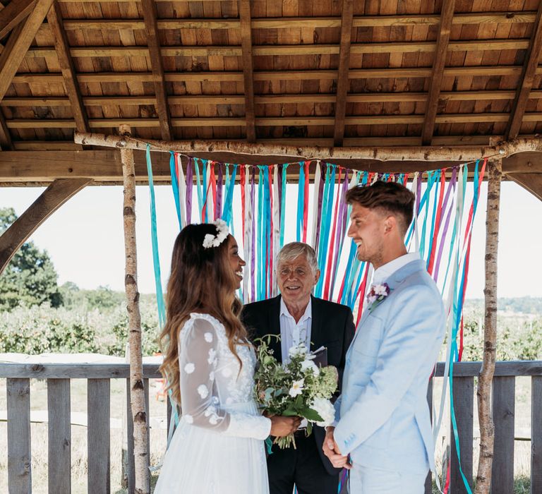 Outdoor wedding ceremony with ribbon backdrop 