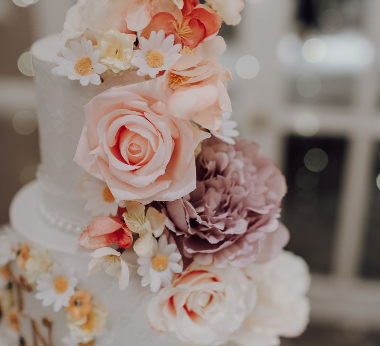 Close up shot of two tiered wedding cake with floral decoration