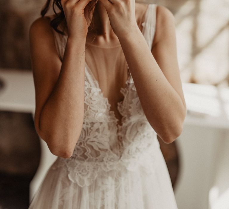 Smiling bride with wedding updo getting ready