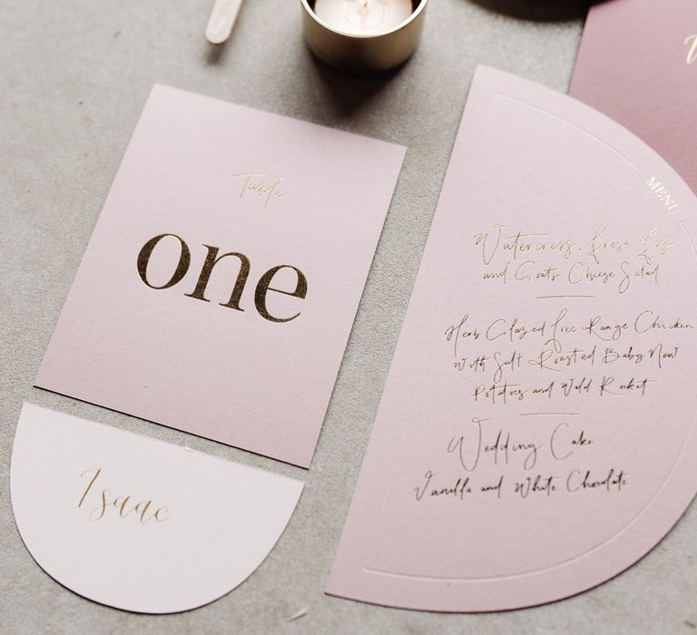 Light pink place settings with gold calligraphy