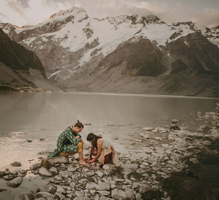 The bride and groom performing a Punjabi ritual at their New Zealand elopement wedding