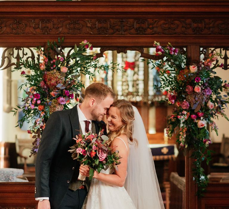 Bride & groom kiss during their wedding ceremony 