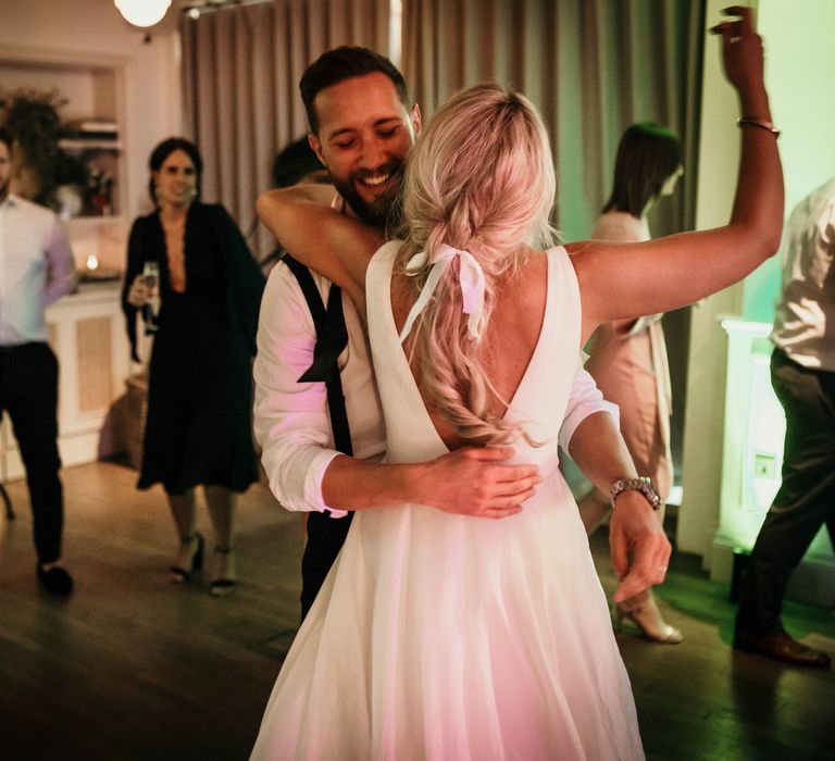 Bride & groom embrace during wedding reception and first dance moment