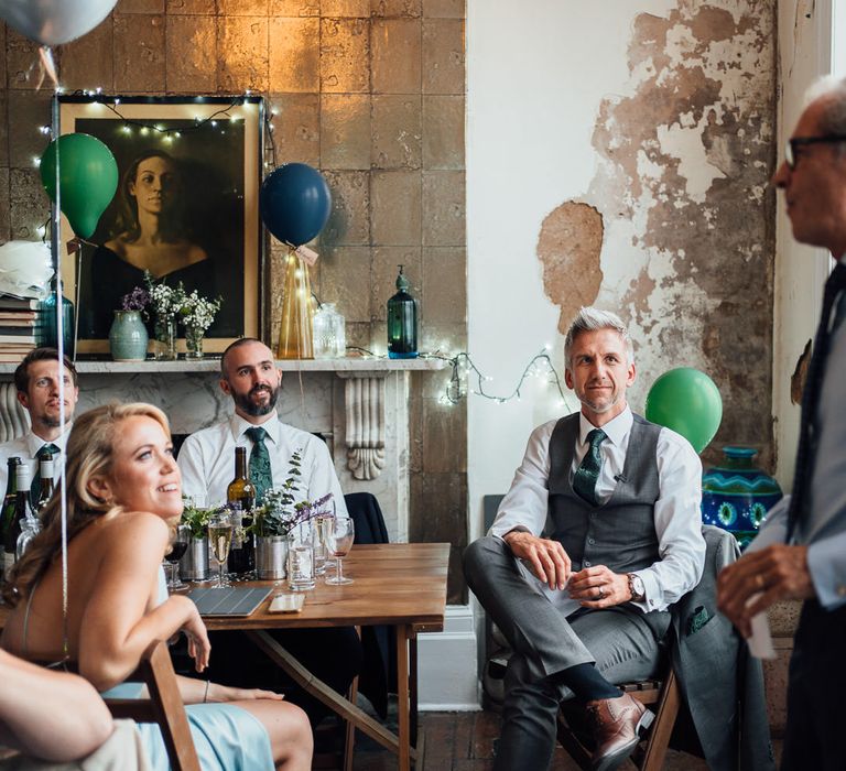 Wedding party guests give speeches during reception