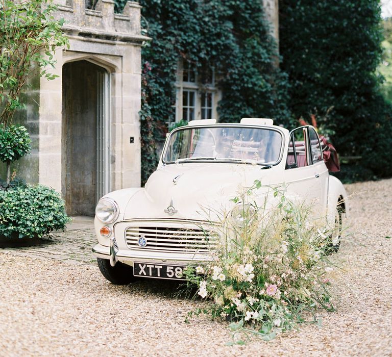 Vintage white Morris minor at Barnsley House for romantic English garden party wedding