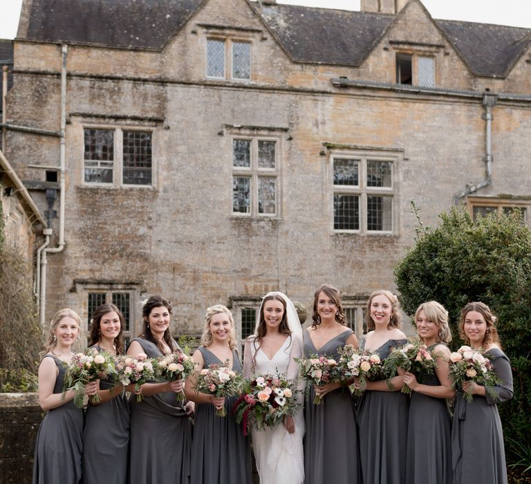 Dark grey bridesmaid dresses with blush bridesmaid bouquets 