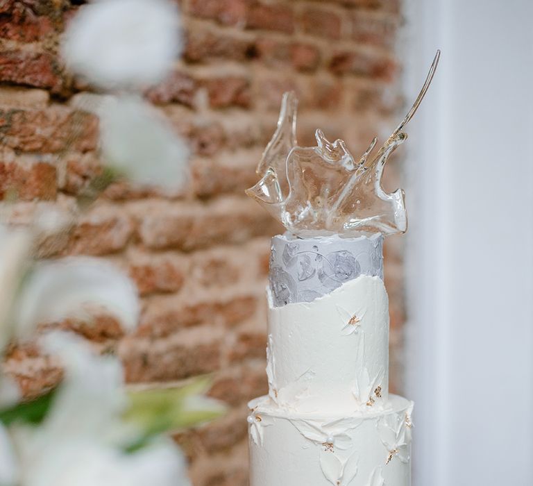 Buttercream wedding cake with sugar sculpture cake topper 