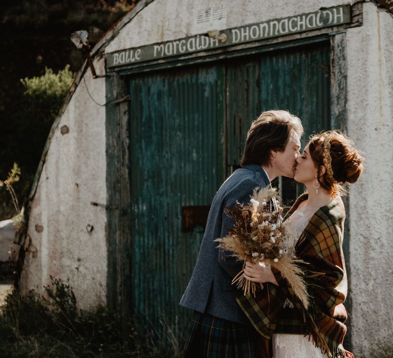 Groom kisses bride on the day of their wedding 