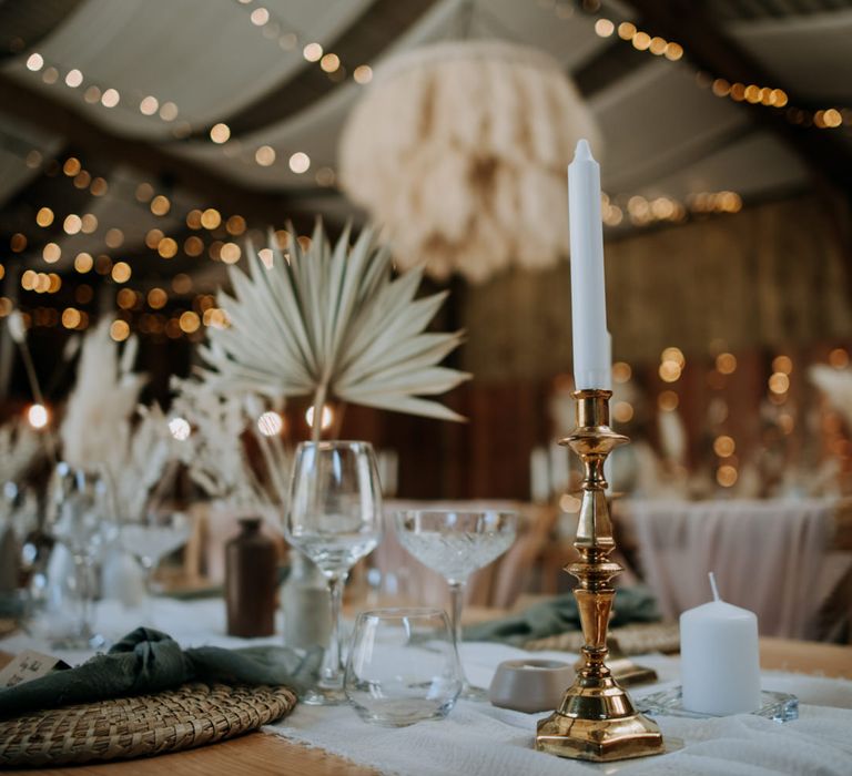 gold candlestick and white taper candle wedding table decor 