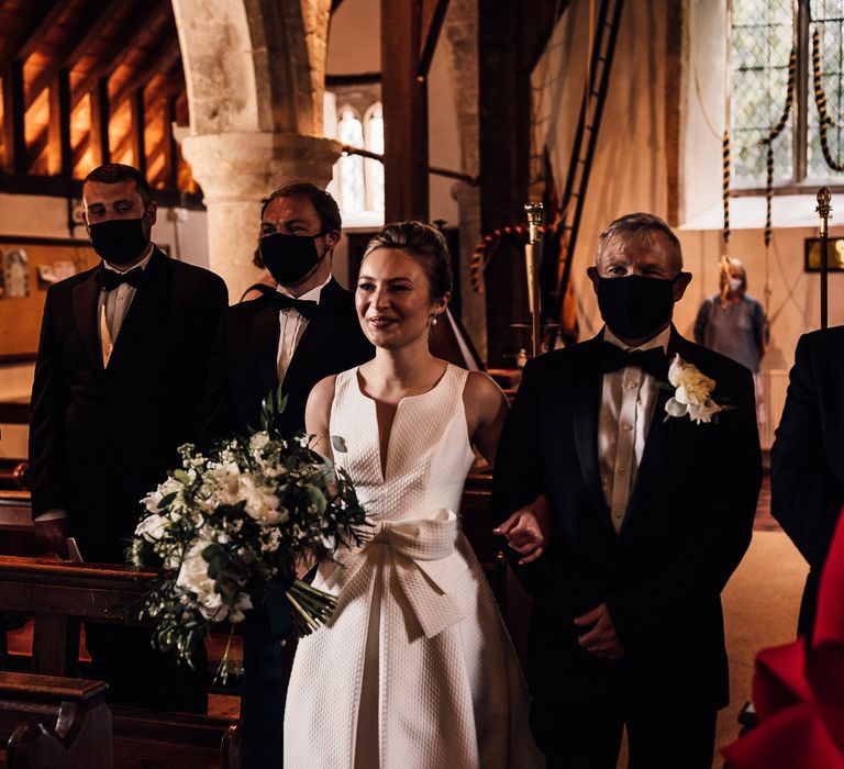 Bride walks down the aisle with her father on her wedding day