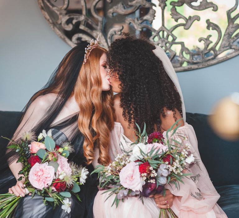 Autism marriage inclusive wedding inspiration with two brides kissing on the sofa in a black dress and pink bridal separates 